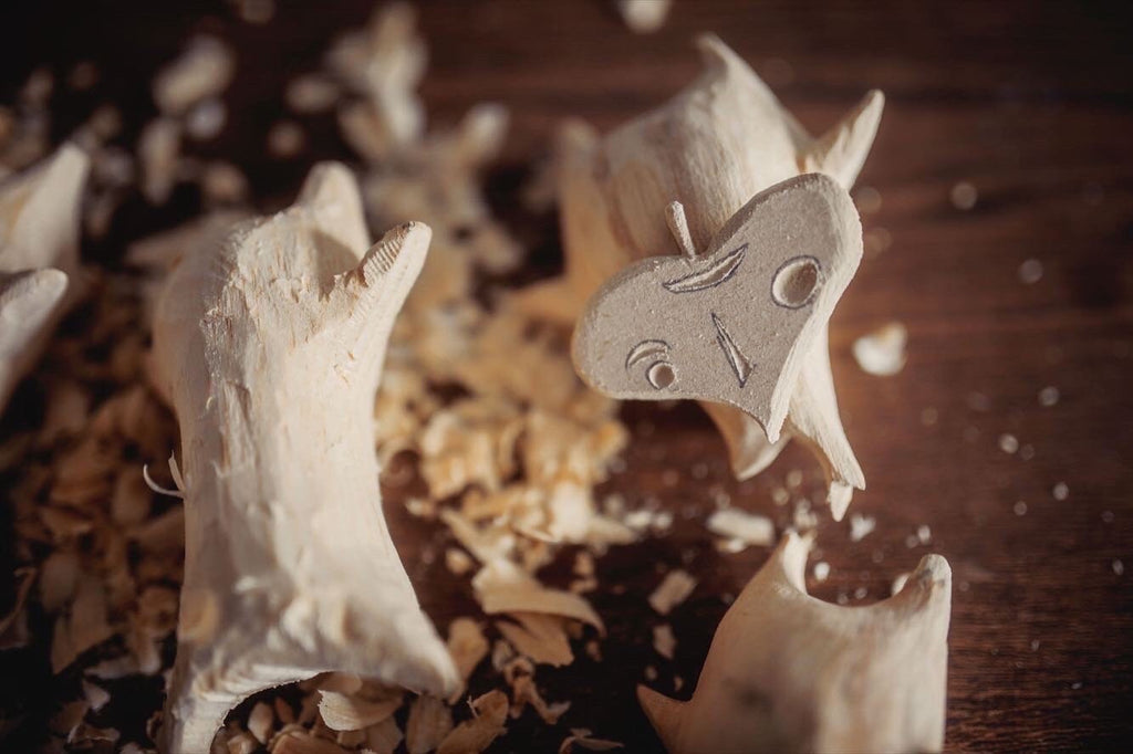 Wooden Korok figures in the making on a wooden surface