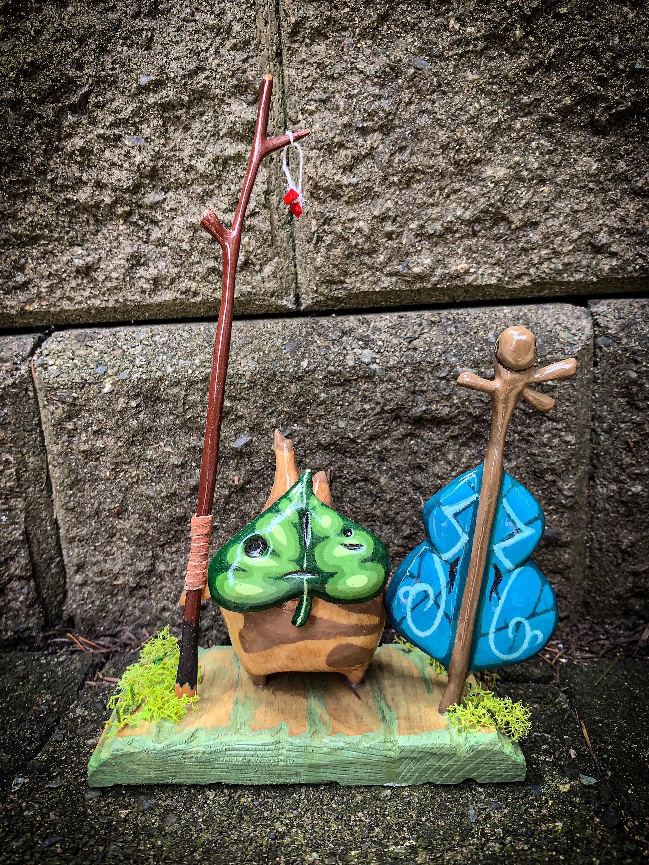 Wooden Makar Statue w/ Violin & Bow - The Legend of Zelda: The Wind Waker against stone background