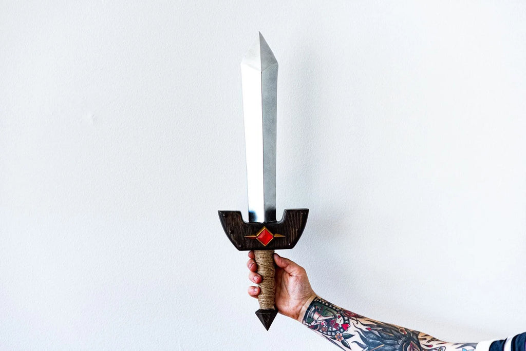 Hand holding a Kokiri sword with a white background