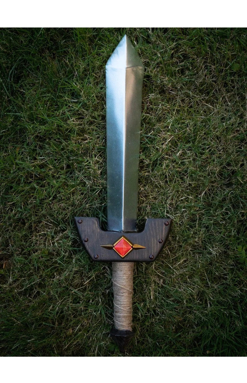 Kokiri Sword with a red emblem on a grassy background