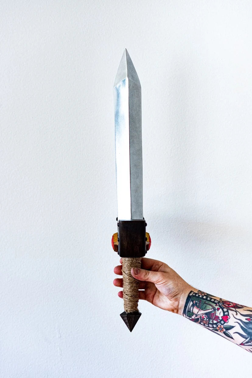 Hand holding a Kokiri sword with a white background